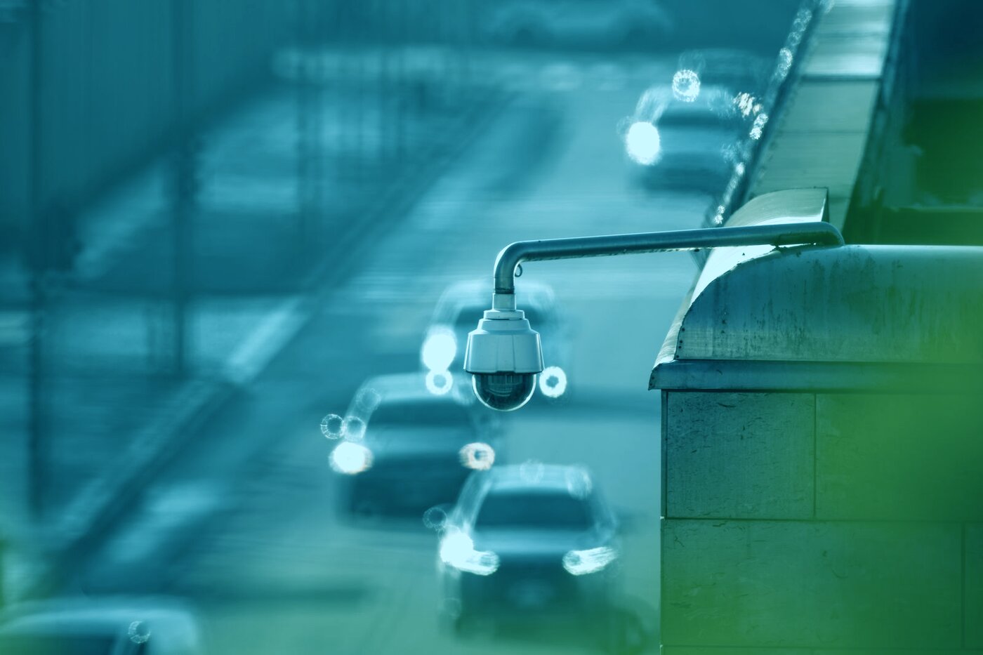 Recognition camera mounted above a lane of queuing traffic approaching an airport terminal forecourt